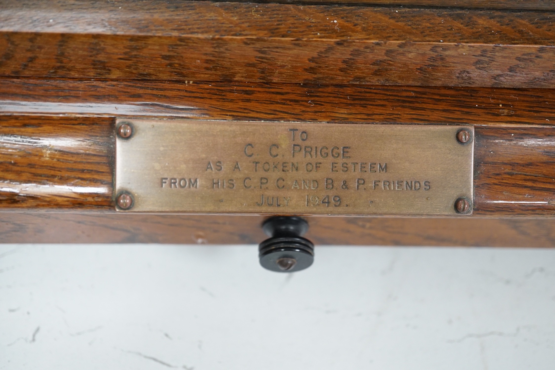 A Negretti and Zambra oak cased barograph number R/20613 with plaque reading ‘To C.C. Prigge as a token of esteem from his C.P.C. and B&P friends July 1949’